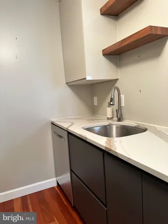 a kitchen with a sink and cabinets