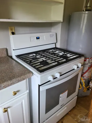 a stove top oven sitting inside of a kitchen