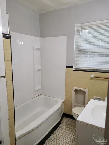 a bathroom with a bathtub and a sink