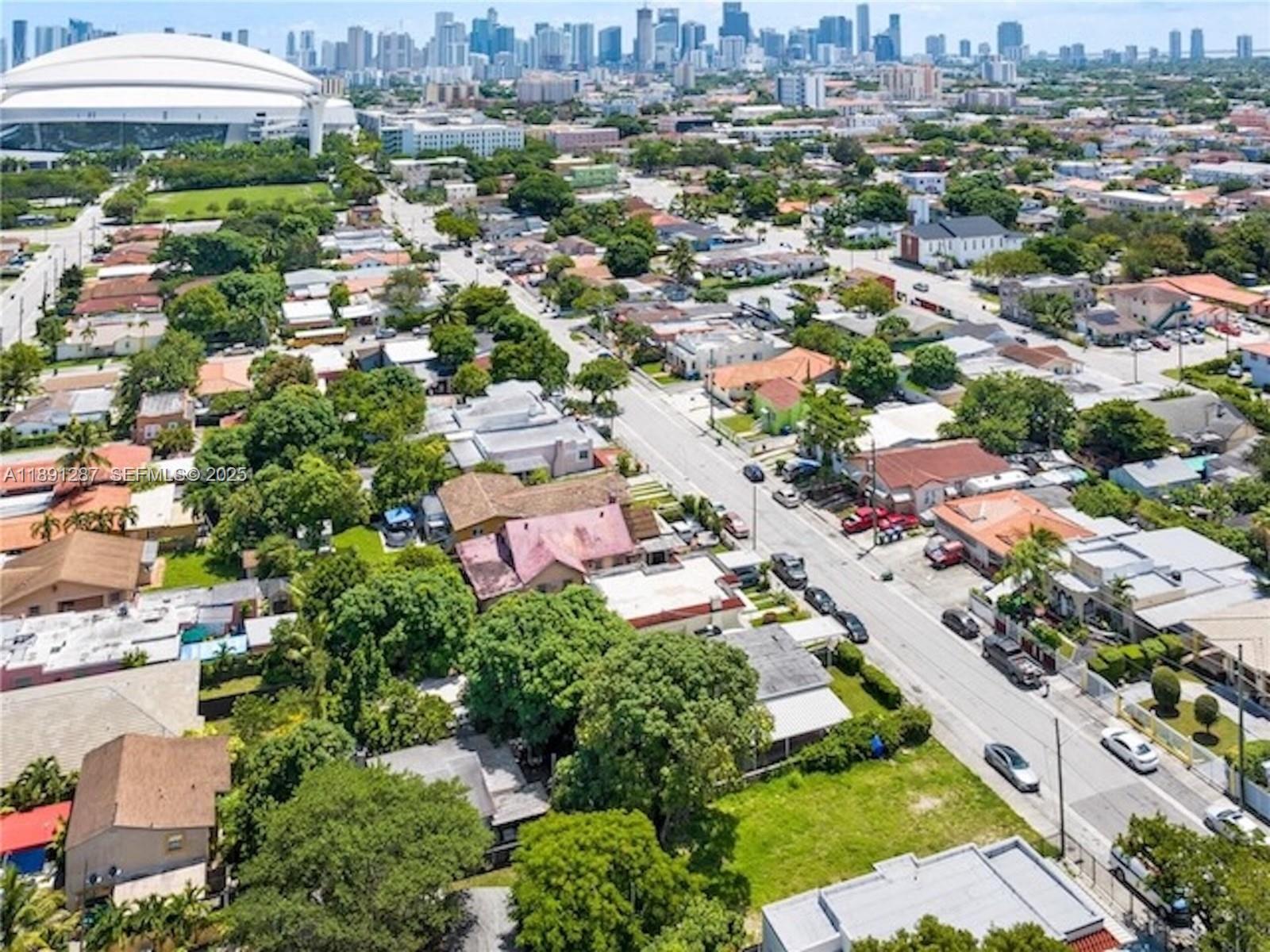 an aerial view of residential houses with outdoor space and street view
