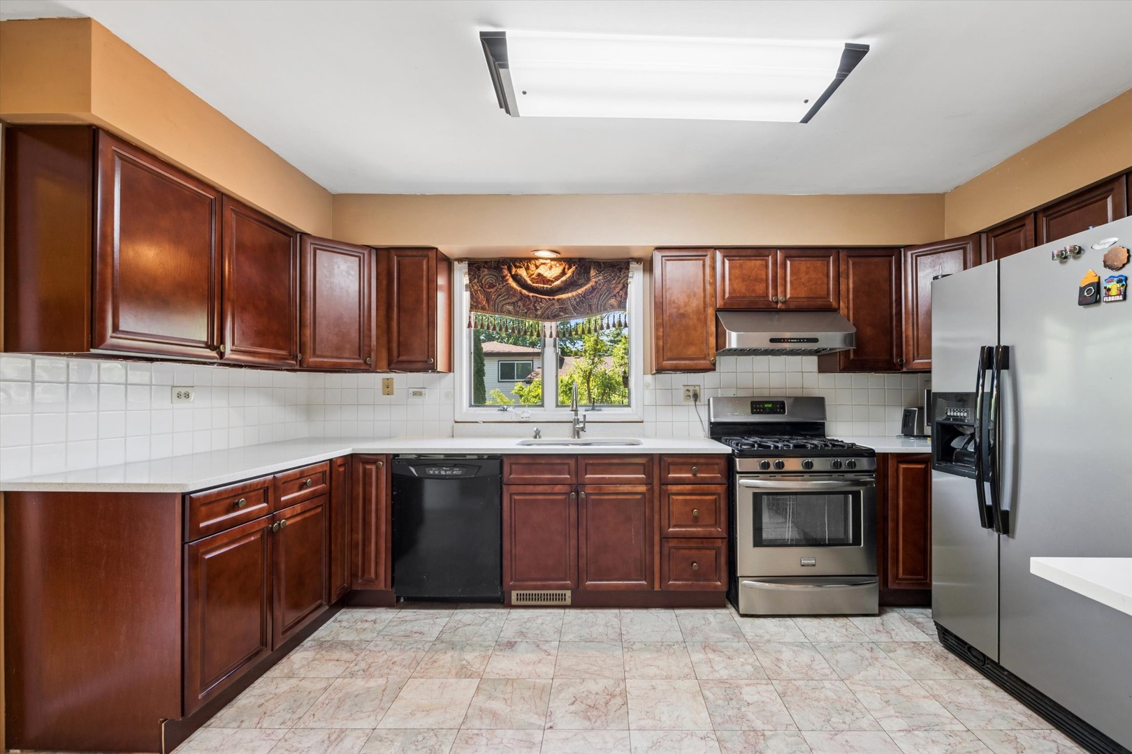 2142 North Summit Street Wheaton, IL 60187 - Photo 12 of 35 a kitchen with stainless steel appliances granite countertop wooden cabinets a stove a sink a island and a window