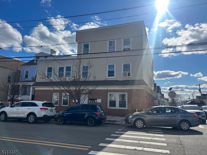 410 1st Avenue, Unit 7 Elizabeth Port, NJ 07206 - Photo 1 of 1 a view of a cars parked in front of a building