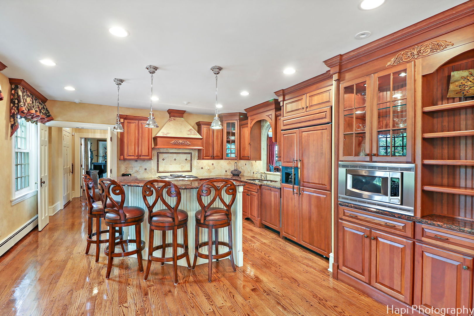 35W543 Miller Road Dundee, IL 60110 - Photo 13 of 68 a kitchen with stainless steel appliances granite countertop a refrigerator a stove top oven and a dining table with wooden floor