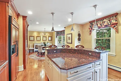 a spacious bedroom with a bed and wooden floor