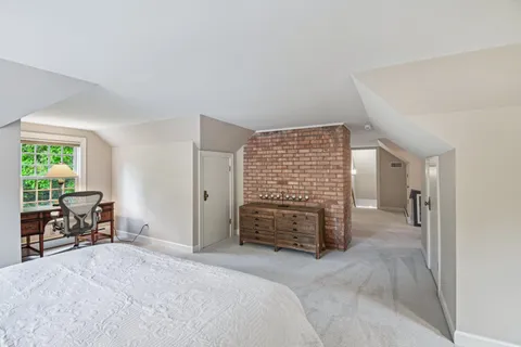 a room with pool table and windows