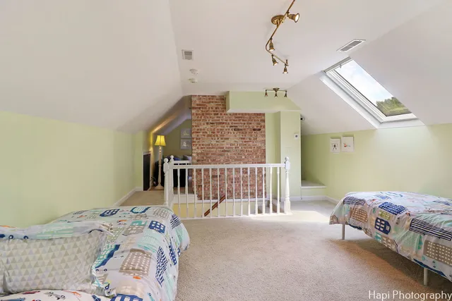 a front view of a building with a garden