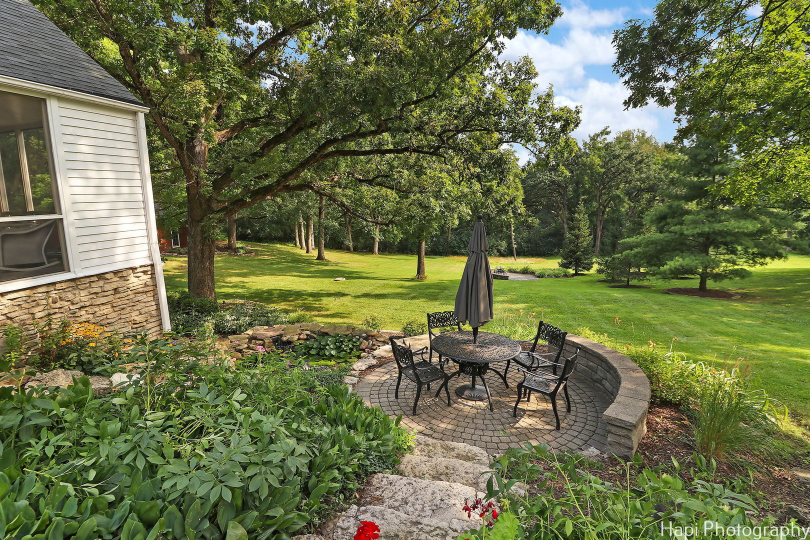 35W543 Miller Road Dundee, IL 60110 - Photo 50 of 68 a view of a patio with table and chairs potted plants and large tree