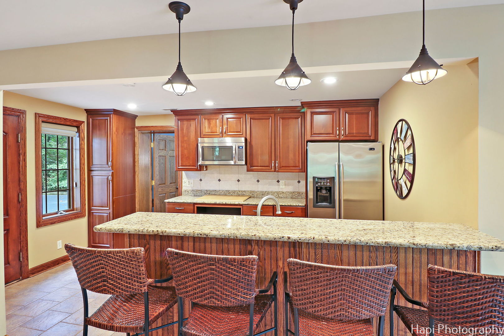 35W543 Miller Road Dundee, IL 60110 - Photo 56 of 68 a dining room with stainless steel appliances granite countertop a sink a stove a dining table and chairs with wooden floor