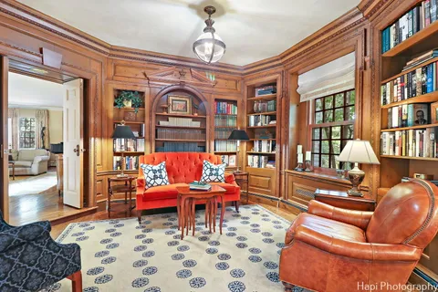 a living room with furniture large windows and a table
