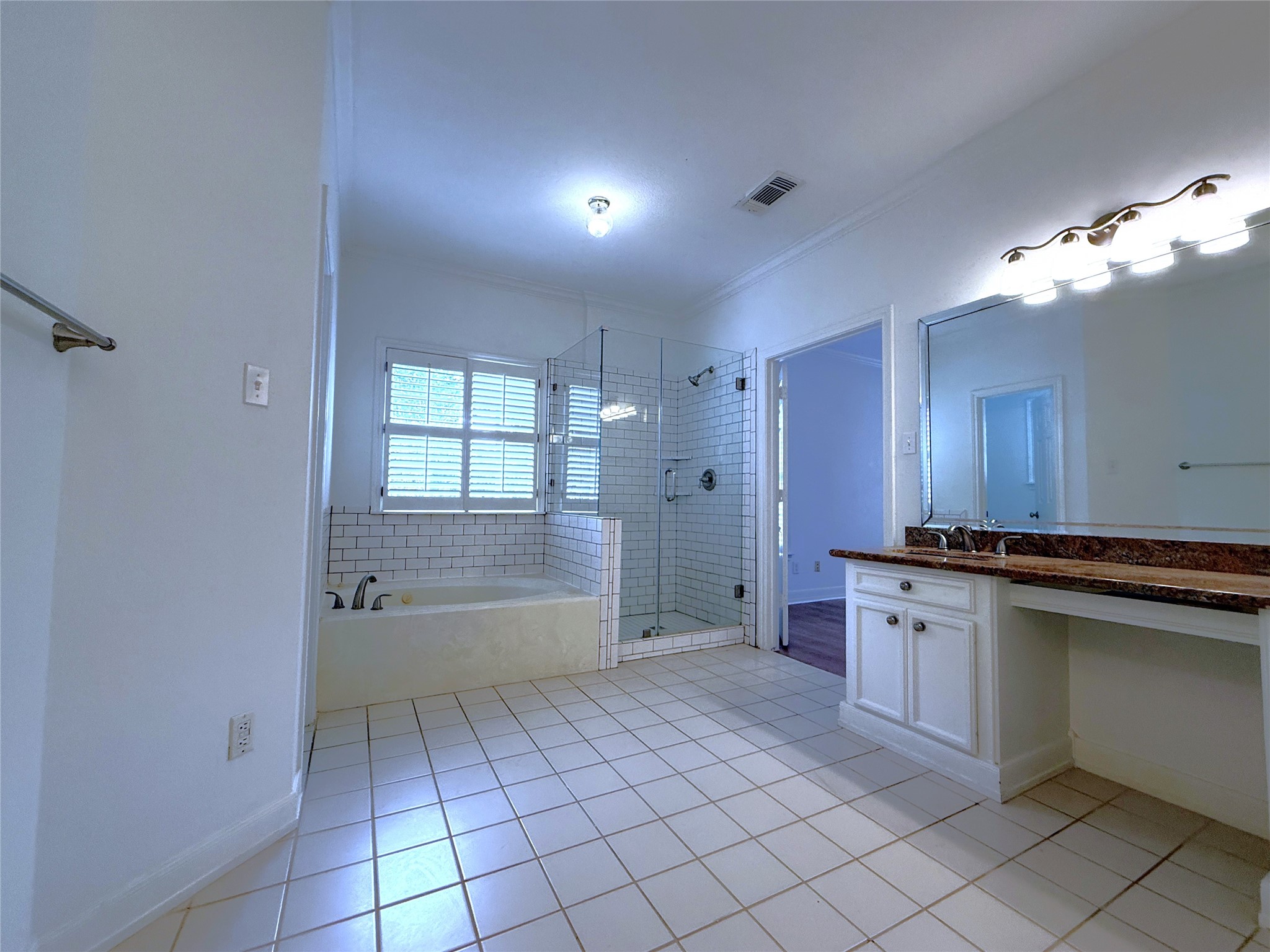 3024 Rice Boulevard Houston, TX 77005 - Photo 21 of 38 Jetted tub & glass framed shower. The largest of the two vanities offers a makeup application station.
