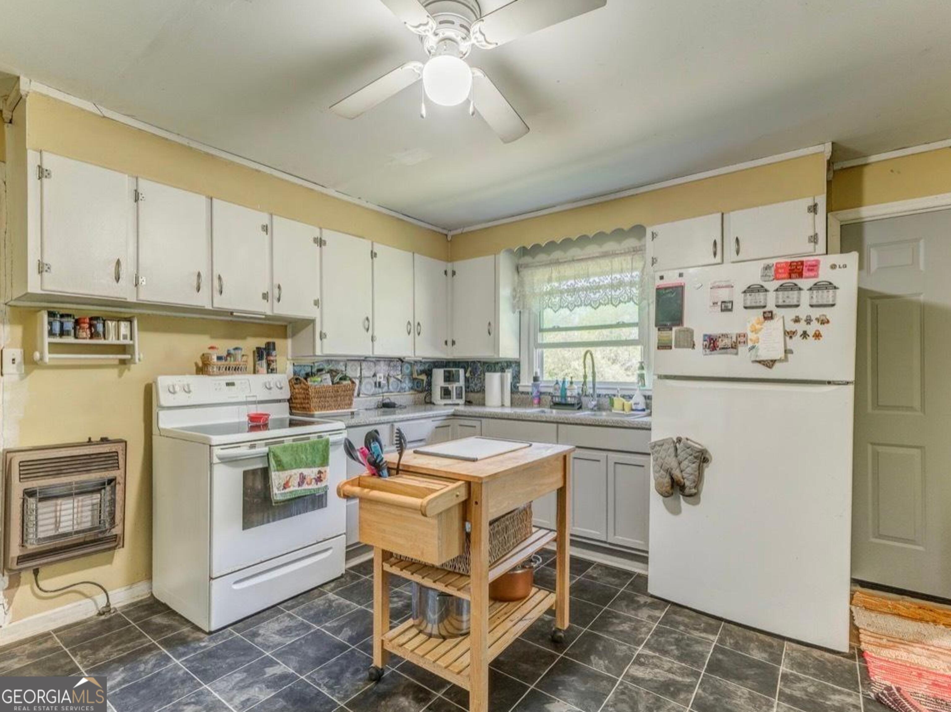 455 Bell Street Menlo, GA 30731 - Photo 7 of 18 a kitchen with a stove a sink and a refrigerator