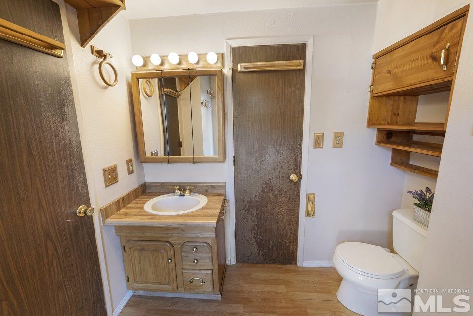 8780 Paloma Way Reno, NV 89506 - Photo 11 of 22 a bathroom with a toilet sink and mirror