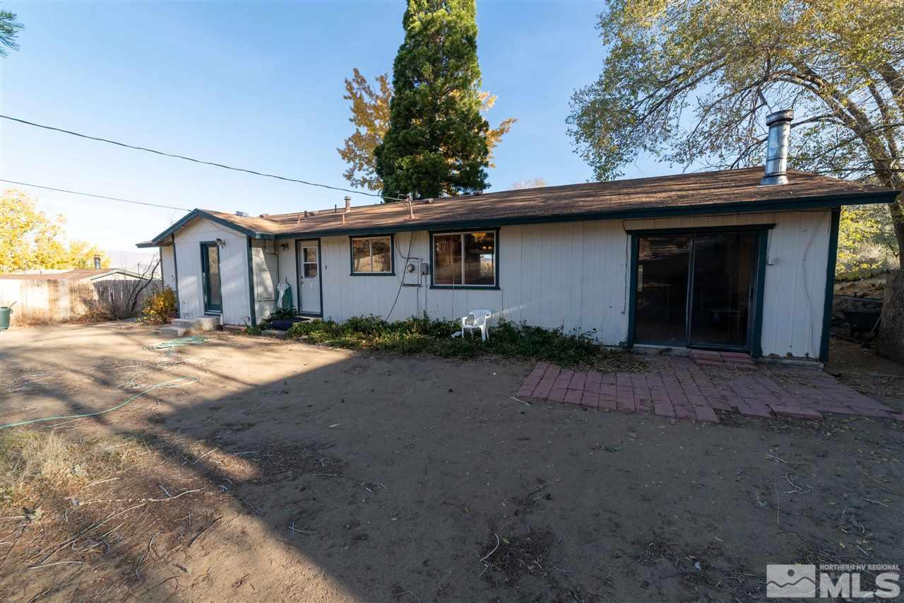 8780 Paloma Way Reno, NV 89506 - Photo 19 of 22 a front view of a house with a yard and garage
