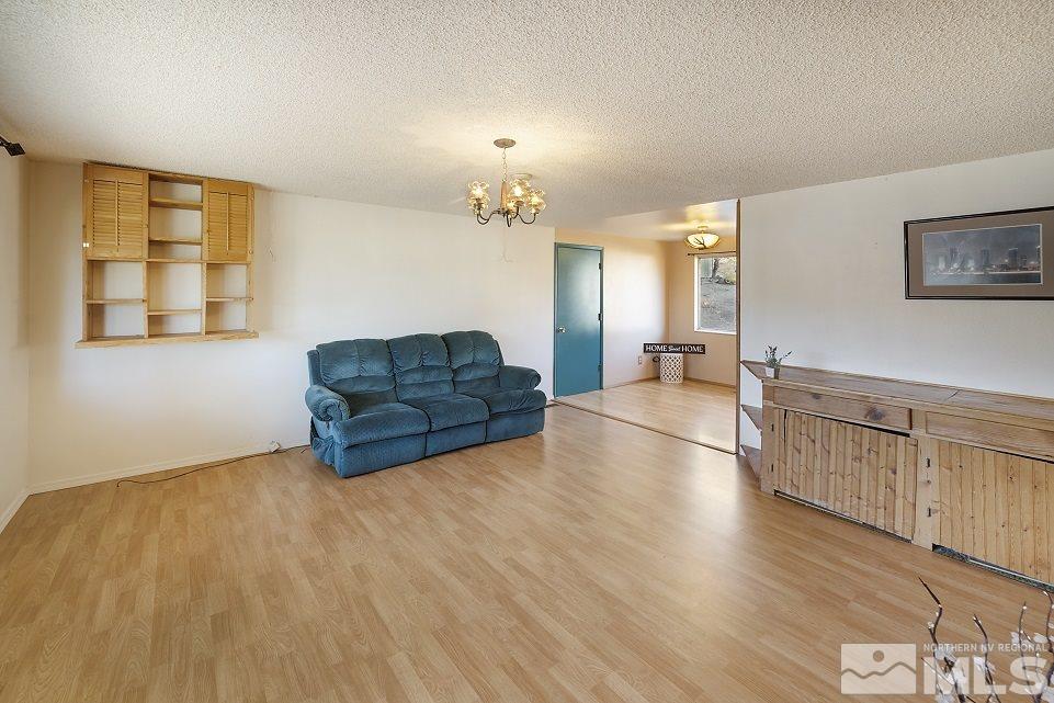 8780 Paloma Way Reno, NV 89506 - Photo 4 of 22 a living room with hard wood floors and a kitchen