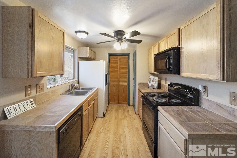 8780 Paloma Way Reno, NV 89506 - Photo 6 of 22 a kitchen with a stove sink and microwave