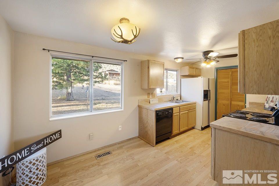8780 Paloma Way Reno, NV 89506 - Photo 7 of 22 a view of a kitchen stove a microwave and cabinets