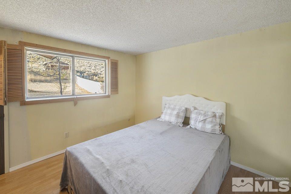 8780 Paloma Way Reno, NV 89506 - Photo 8 of 22 a bedroom with a bed and a window
