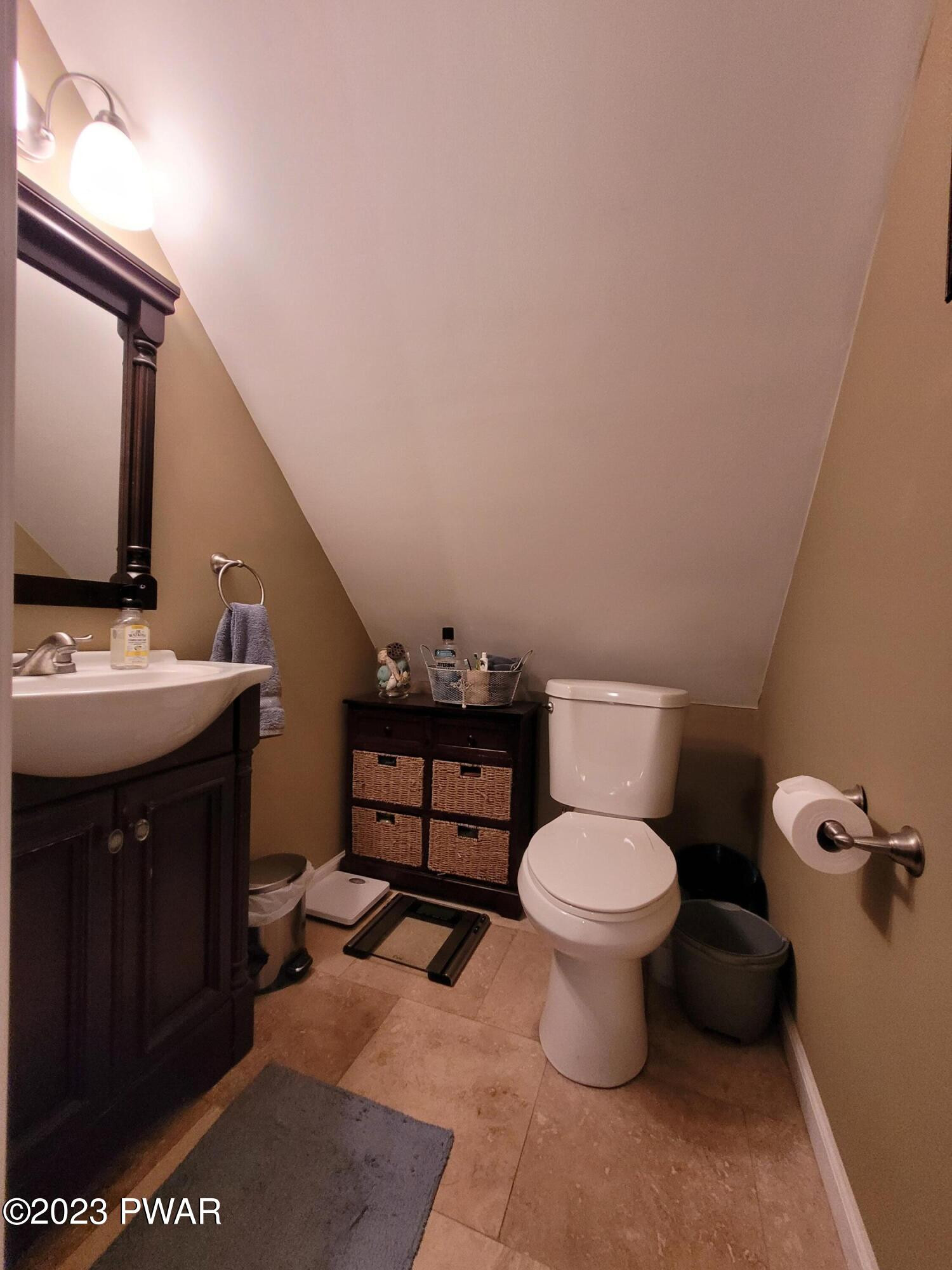 122 Hemlock Road Milford, PA 18337 - Photo 13 of 19 a bathroom with a toilet a sink and mirror
