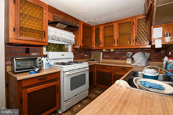 313 Sassafras Street Millville, NJ 08332 - Photo 16 of 25 a kitchen with stainless steel appliances granite countertop a stove a sink and a microwave