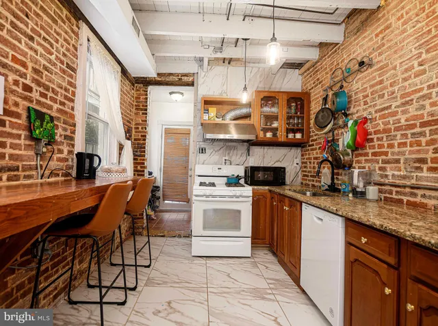 a kitchen with stainless steel appliances granite countertop a sink and cabinets