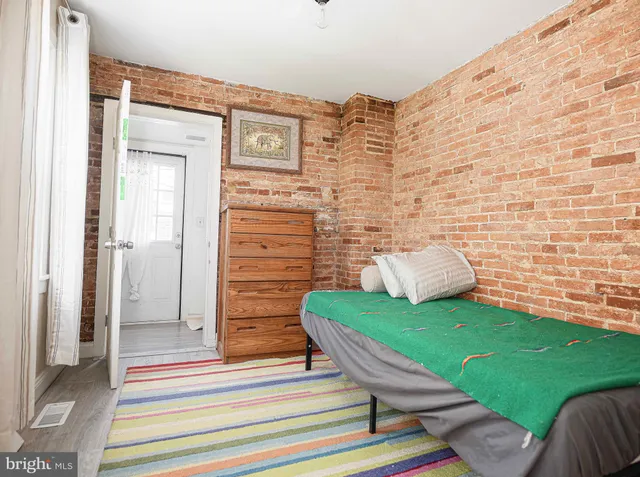 a view of a bedroom with a bed and a chair