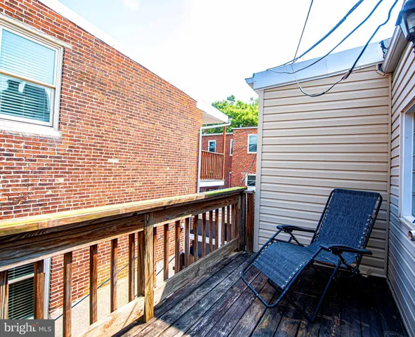 a view of a wooden chairs on the deck