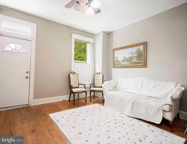 a living room with a bed furniture and a window