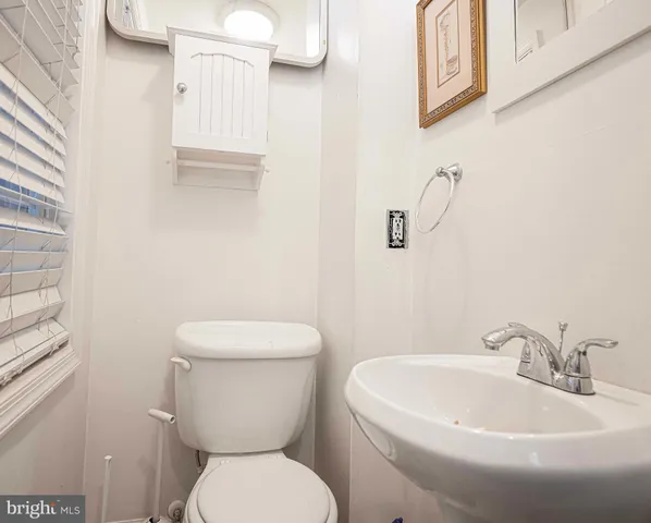 a white toilet sitting next to a white sink