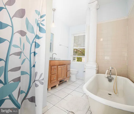 a bathroom with a sink and mirror with toilet