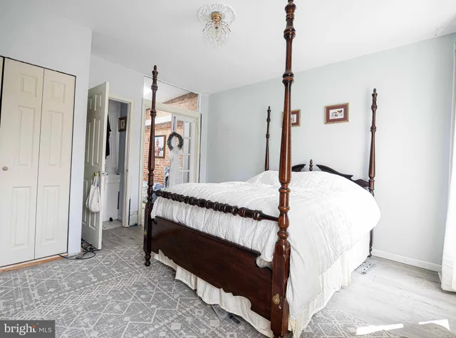 a bed sitting in a bedroom next to a window