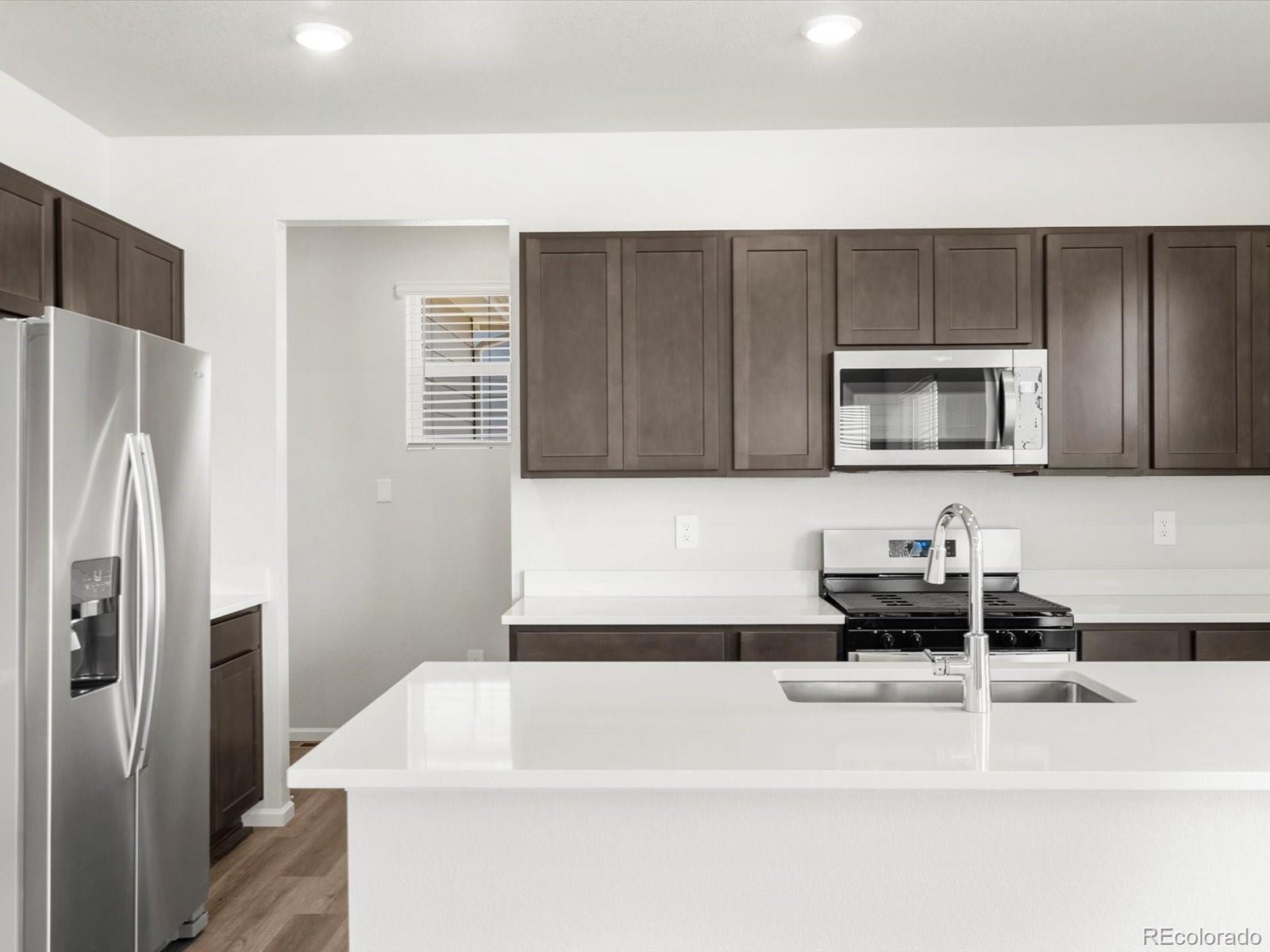 7300 West 27th St Road Greeley, CO 80634 - Photo 11 of 39 a kitchen with a sink and a refrigerator