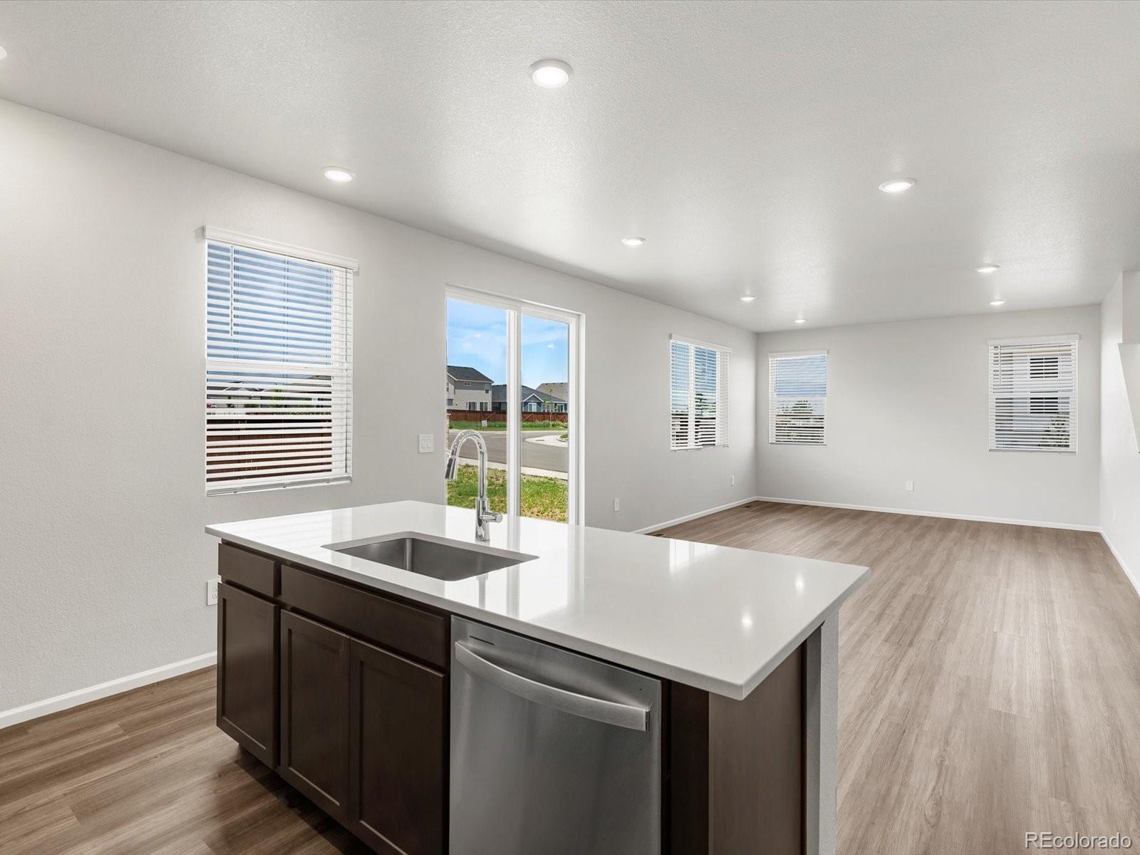 7300 West 27th St Road Greeley, CO 80634 - Photo 13 of 39 a kitchen with a sink cabinets and wooden floor