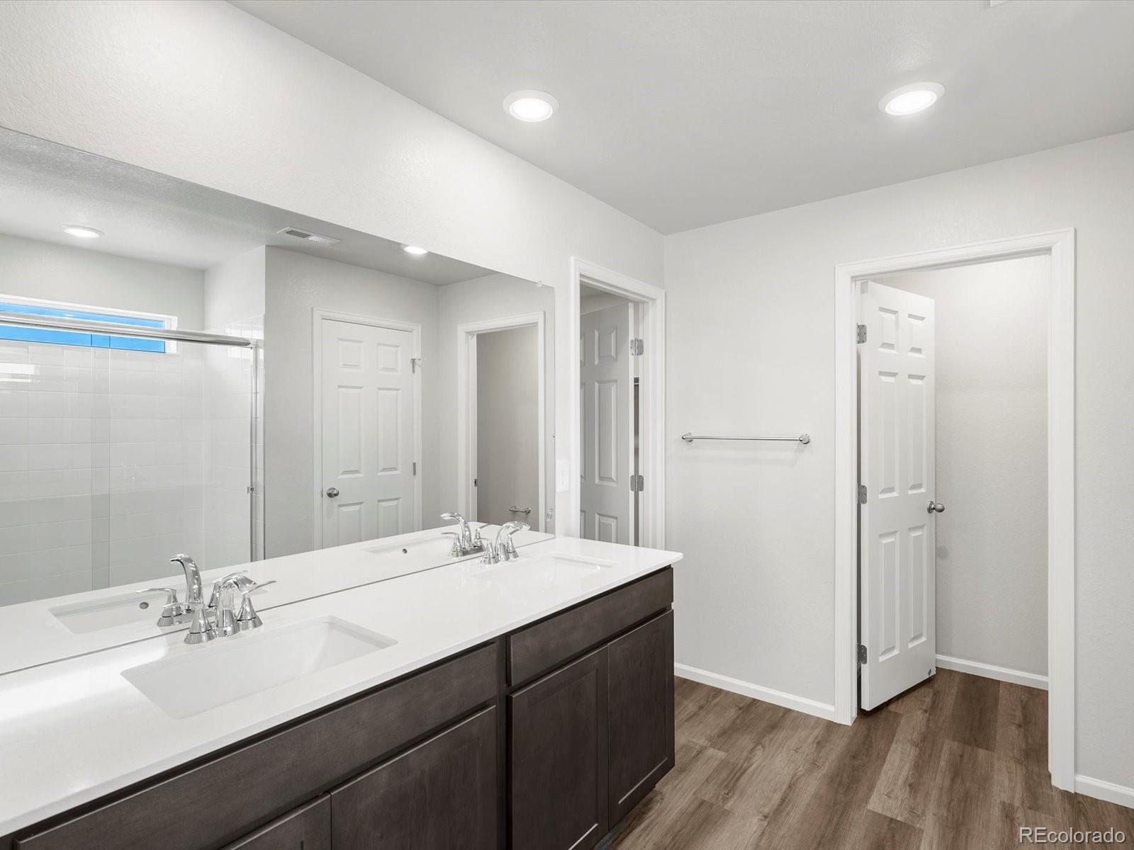 7300 West 27th St Road Greeley, CO 80634 - Photo 19 of 39 a bathroom with a double vanity sink and mirror