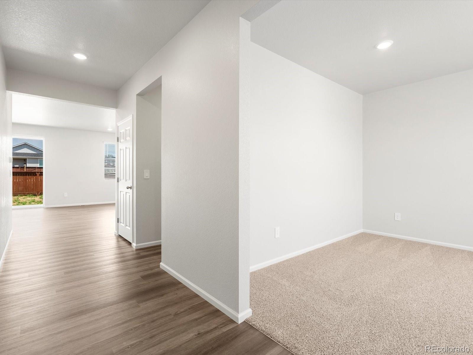 7300 West 27th St Road Greeley, CO 80634 - Photo 2 of 39 a view of a hallway with wooden floor