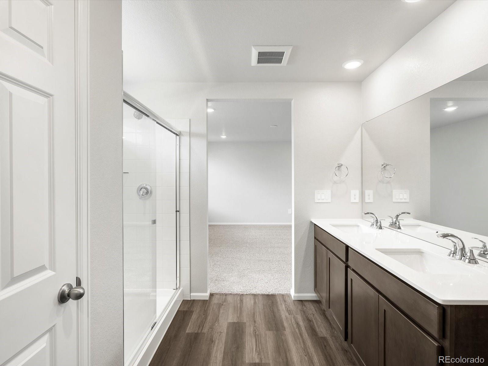 7300 West 27th St Road Greeley, CO 80634 - Photo 25 of 39 a bathroom with a sink a mirror and a shower