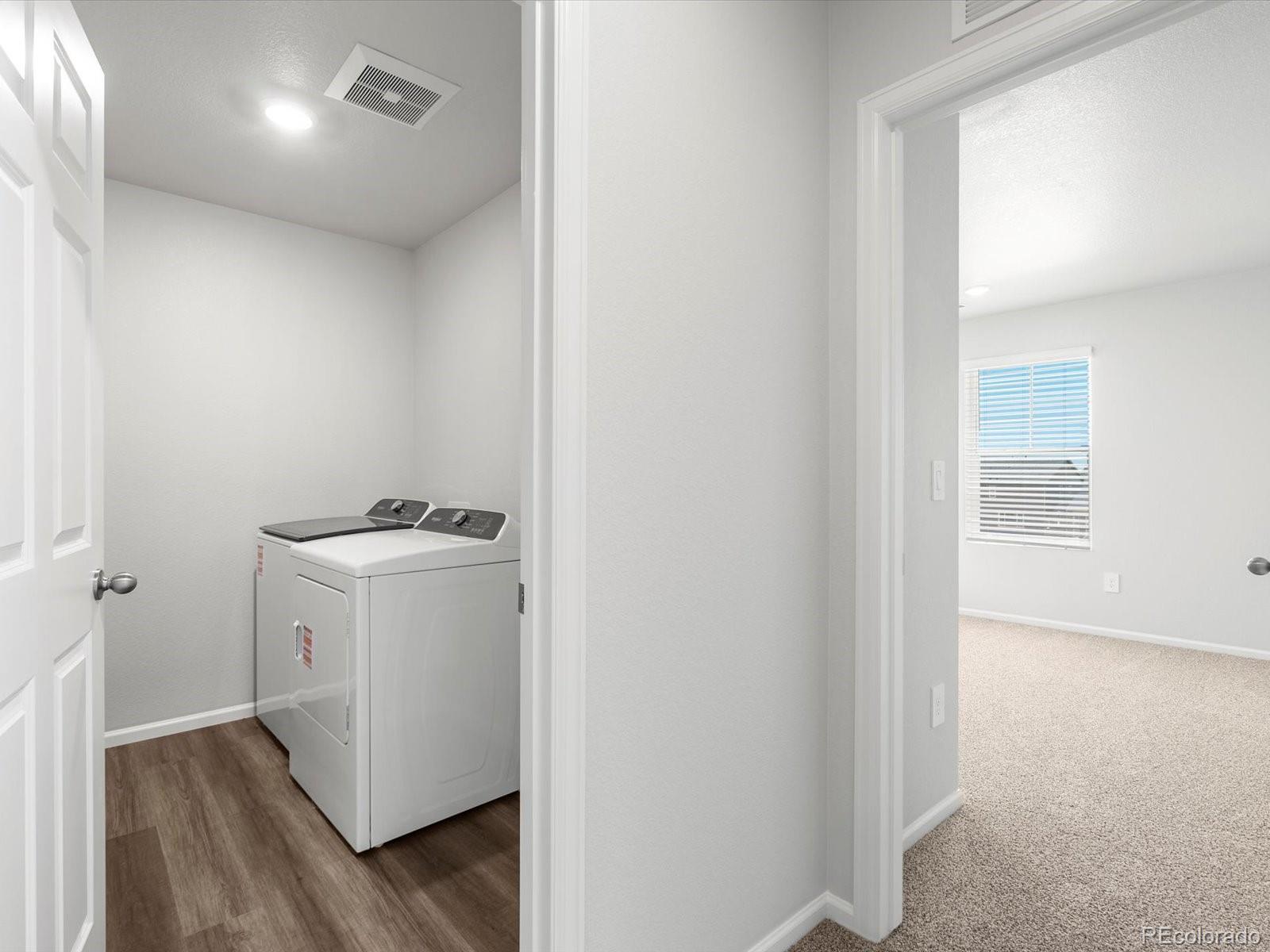 7300 West 27th St Road Greeley, CO 80634 - Photo 28 of 39 a utility room with wooden floor washer and dryer