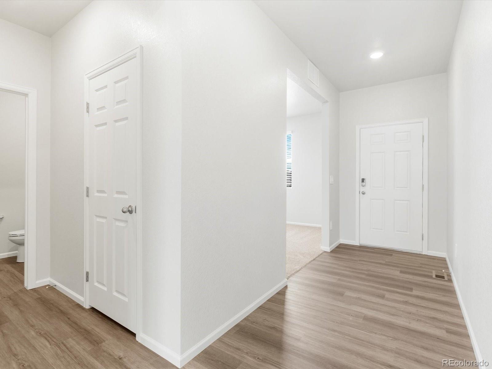 7300 West 27th St Road Greeley, CO 80634 - Photo 3 of 39 a view of a hallway with wooden floor
