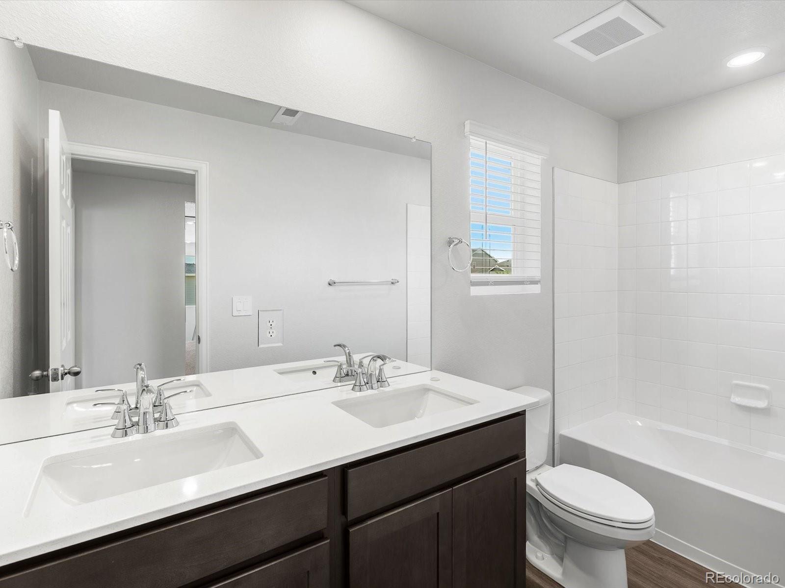 7300 West 27th St Road Greeley, CO 80634 - Photo 35 of 39 a bathroom with a sink a toilet a shower and a mirror