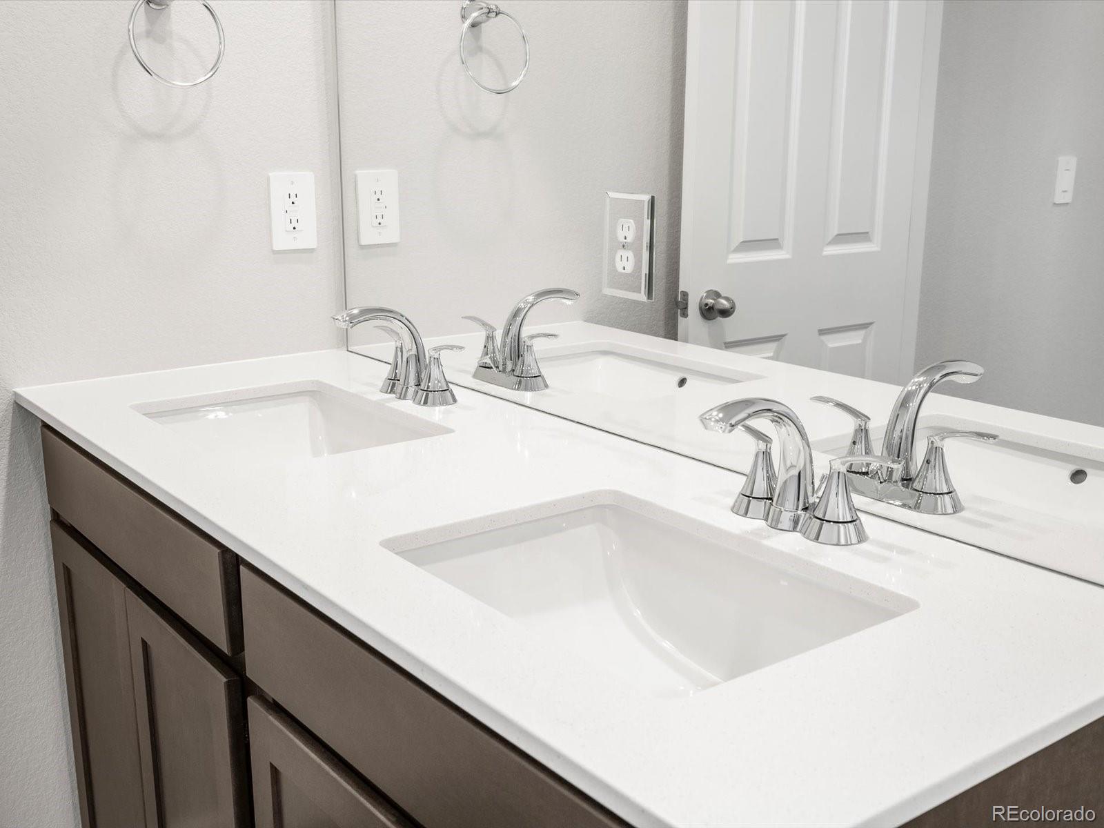 7300 West 27th St Road Greeley, CO 80634 - Photo 37 of 39 a bathroom with double sink and a mirror