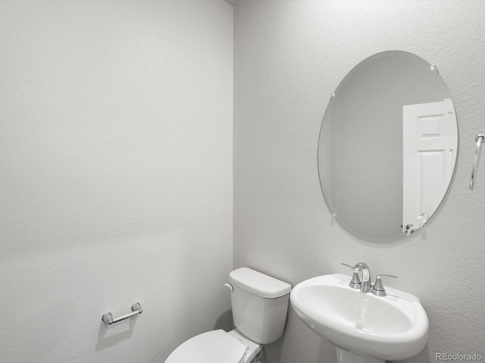 7300 West 27th St Road Greeley, CO 80634 - Photo 5 of 39 a bathroom with a toilet a sink and mirror