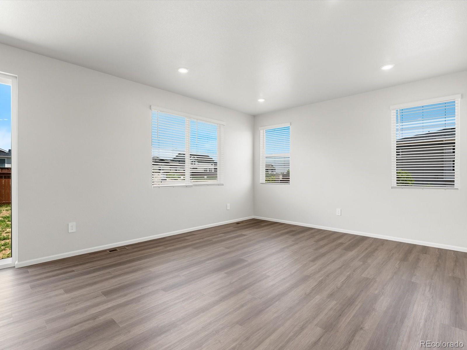 7300 West 27th St Road Greeley, CO 80634 - Photo 6 of 39 an empty room with wooden floor and windows
