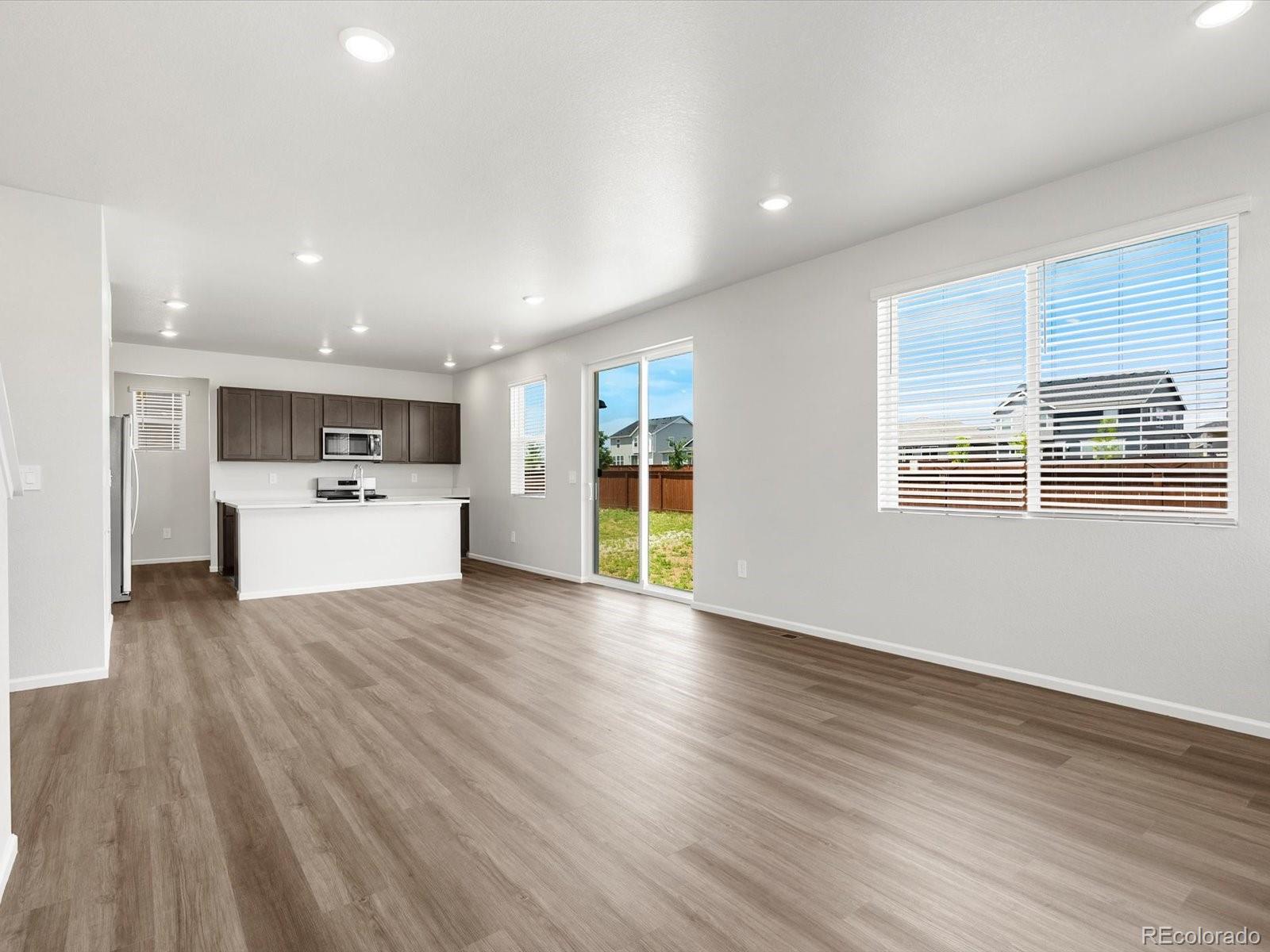 7300 West 27th St Road Greeley, CO 80634 - Photo 7 of 39 a view of a kitchen with a sink wooden floor and windows