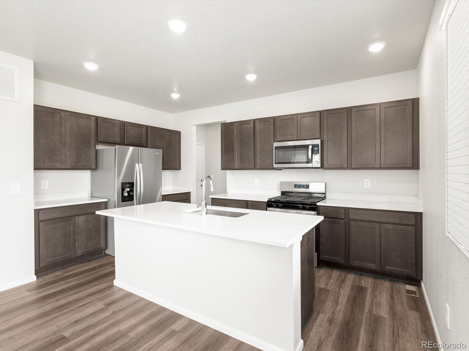 7300 West 27th St Road Greeley, CO 80634 - Photo 9 of 39 a kitchen with stainless steel appliances a refrigerator stove microwave and sink