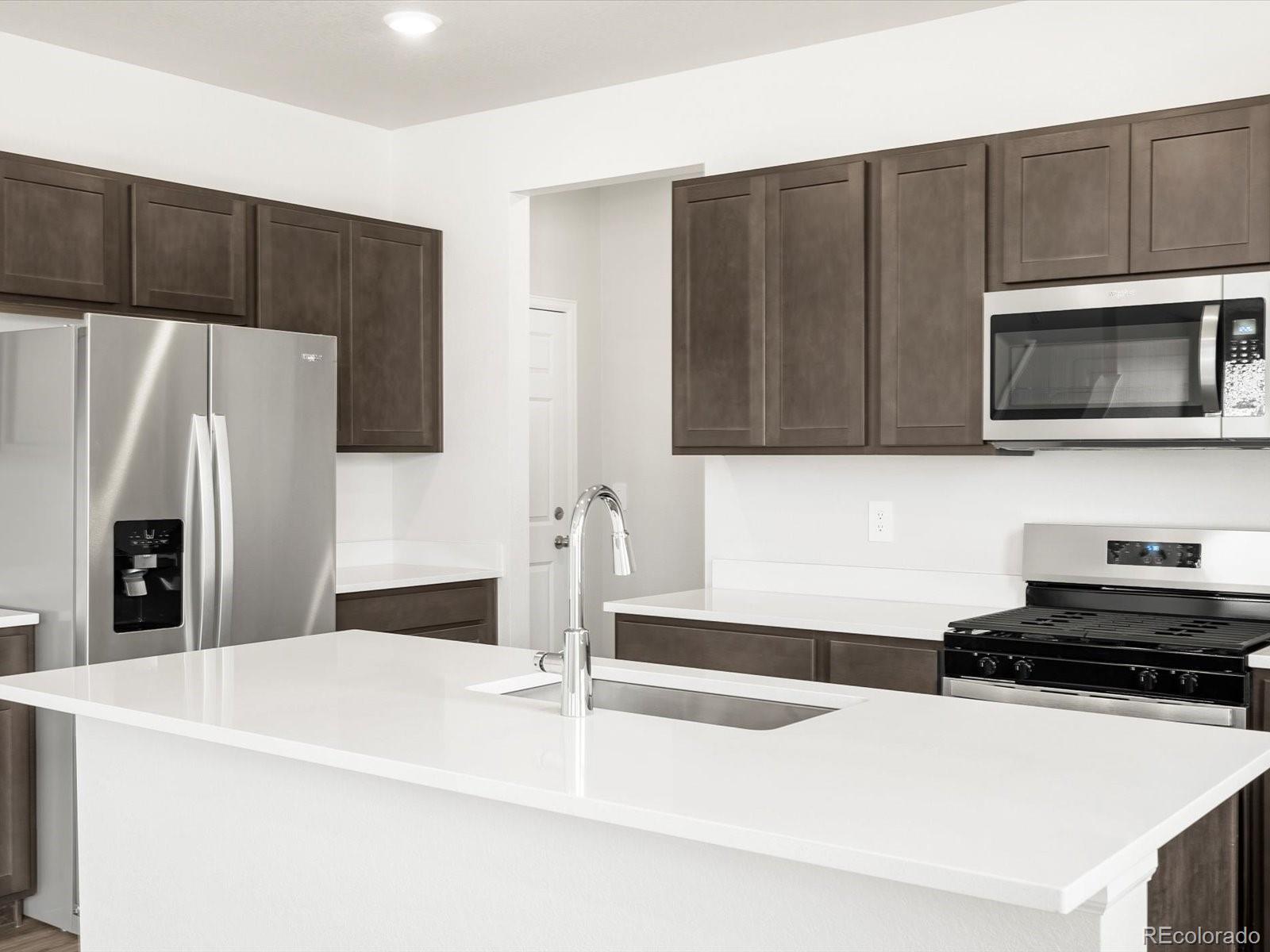 7300 West 27th St Road Greeley, CO 80634 - Photo 10 of 39 a kitchen with stainless steel appliances a refrigerator a stove top oven a sink and dishwasher