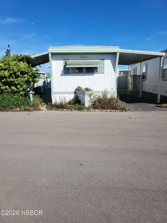 a front view of a house with a yard and a garage