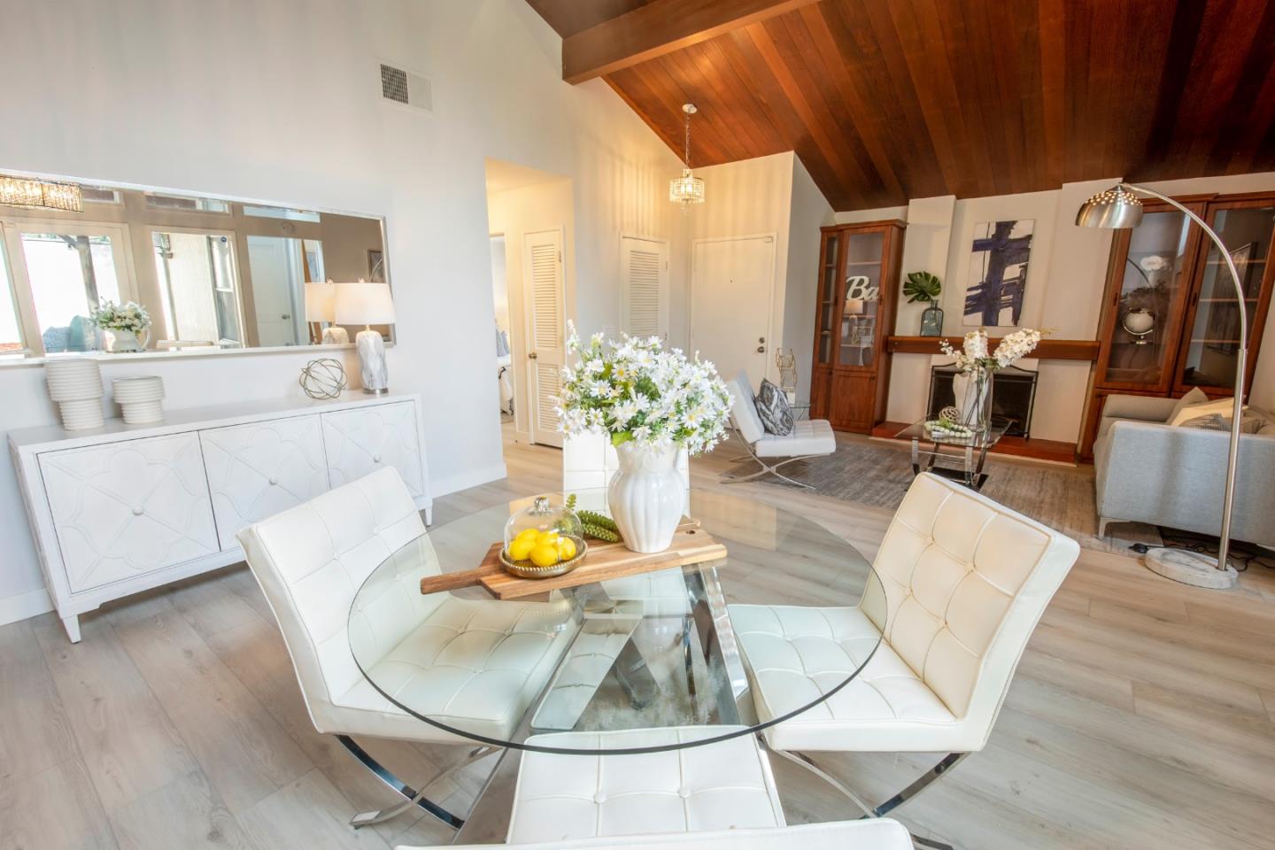 22991 Longdown Road Cupertino, CA 95014 - Photo 11 of 31 a living room with furniture and a chandelier
