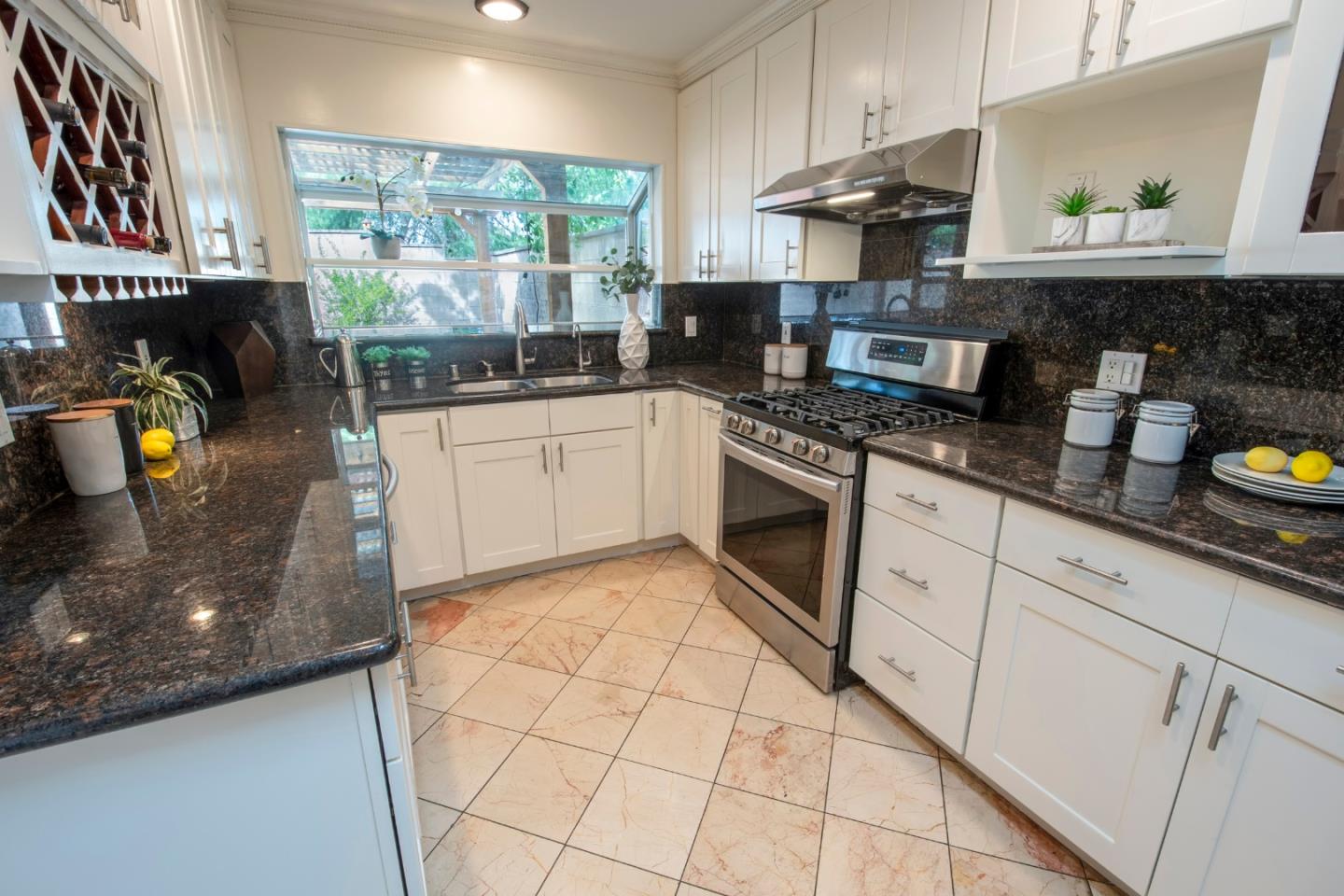 22991 Longdown Road Cupertino, CA 95014 - Photo 15 of 31 a kitchen with stainless steel appliances granite countertop a stove a sink and a counter space