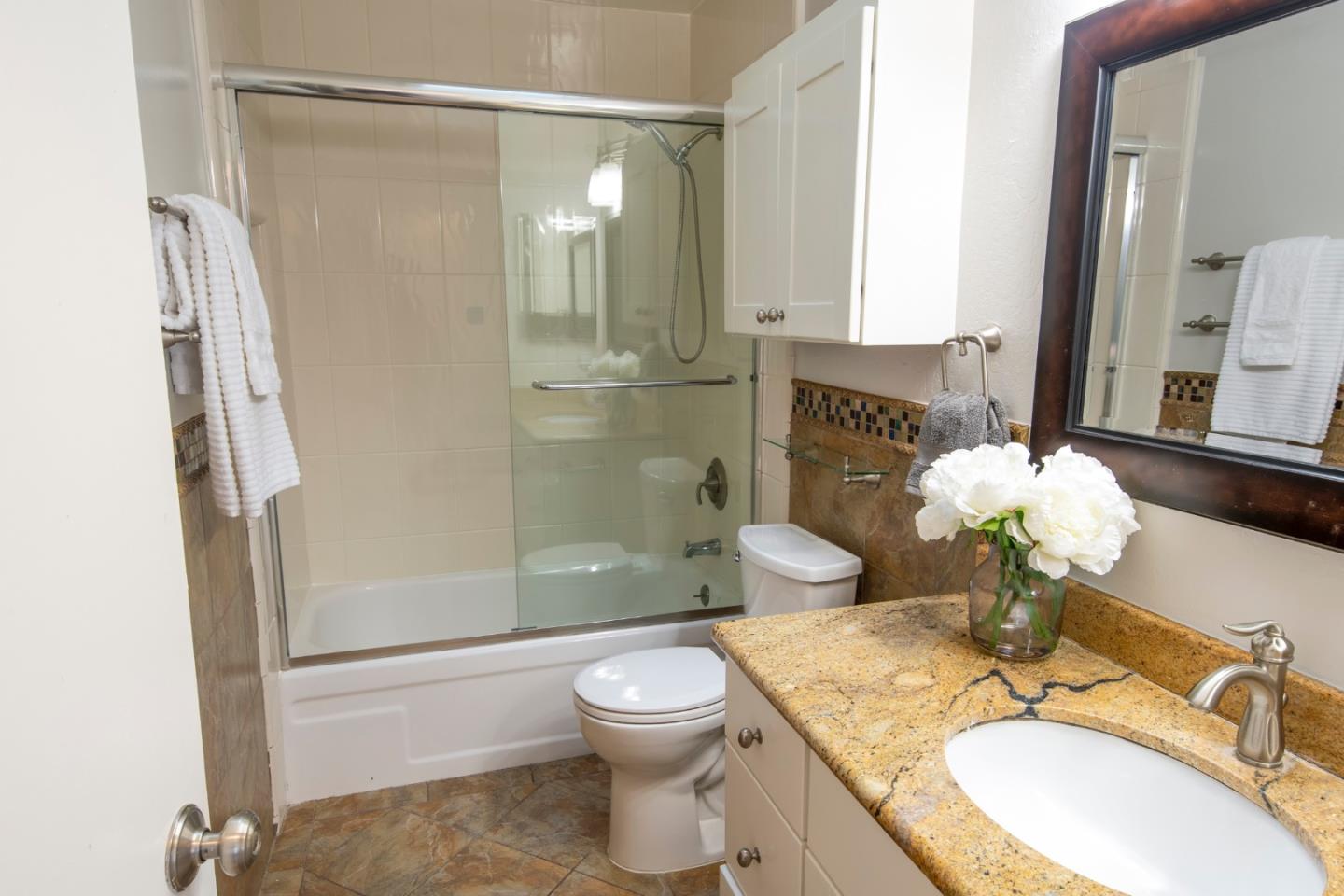 22991 Longdown Road Cupertino, CA 95014 - Photo 24 of 31 a bathroom with a granite countertop sink toilet and shower