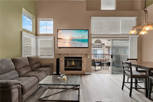 a living room with furniture a fireplace and a flat screen tv