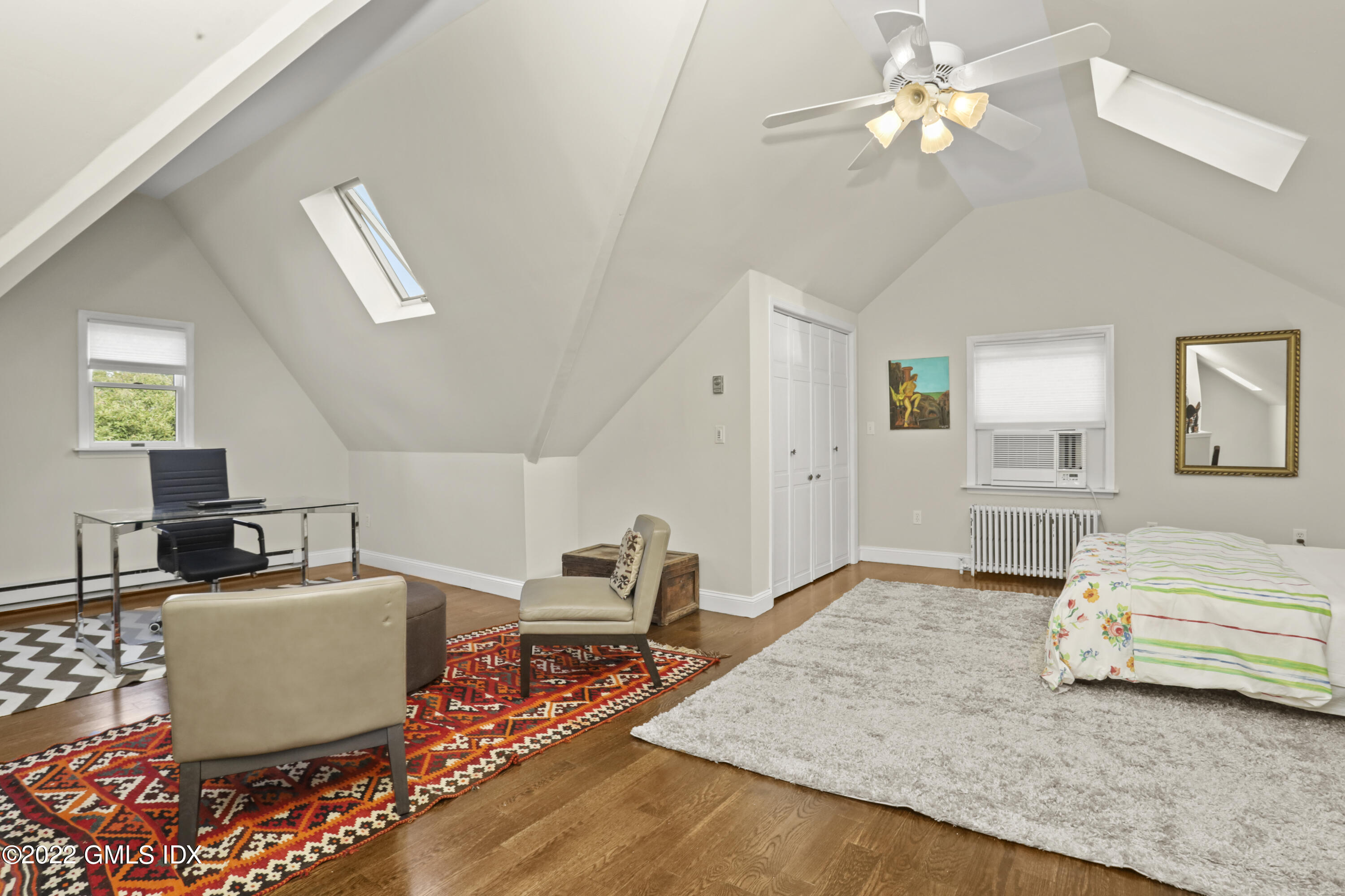 12 Maher Avenue Greenwich, CT 06830 - Photo 21 of 34 a bedroom with furniture and a chandelier